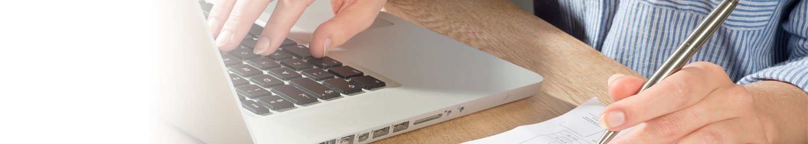 man with laptop and pen