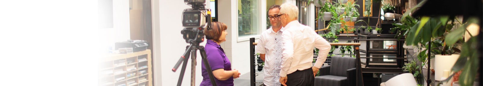 Brian Keen conversing with a man and a woman