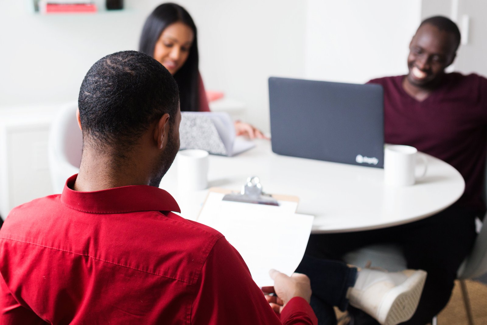 Three people having a business meeting at a roundtable
