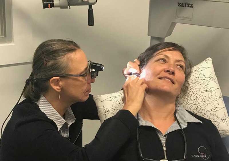 middle-aged woman undergoing an ear check-up