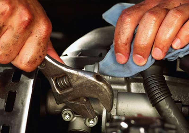 man holding adjustable wrench