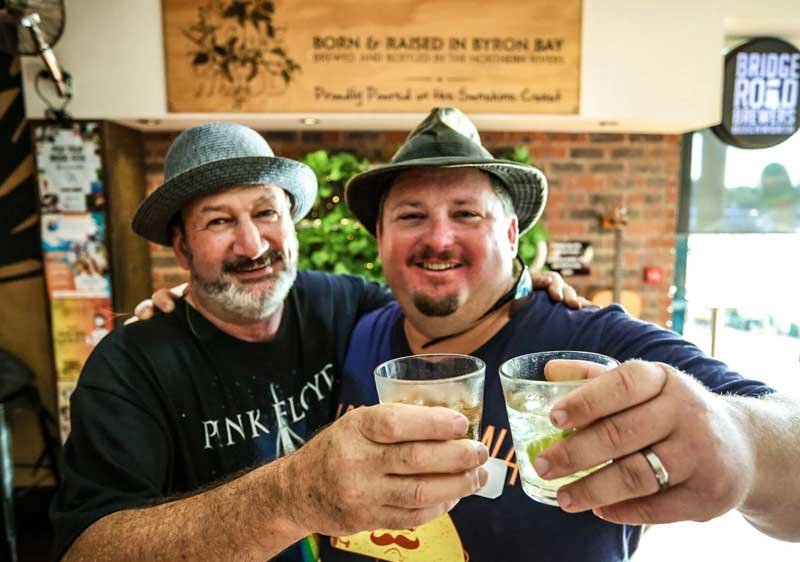 Two men clinking beer glasses