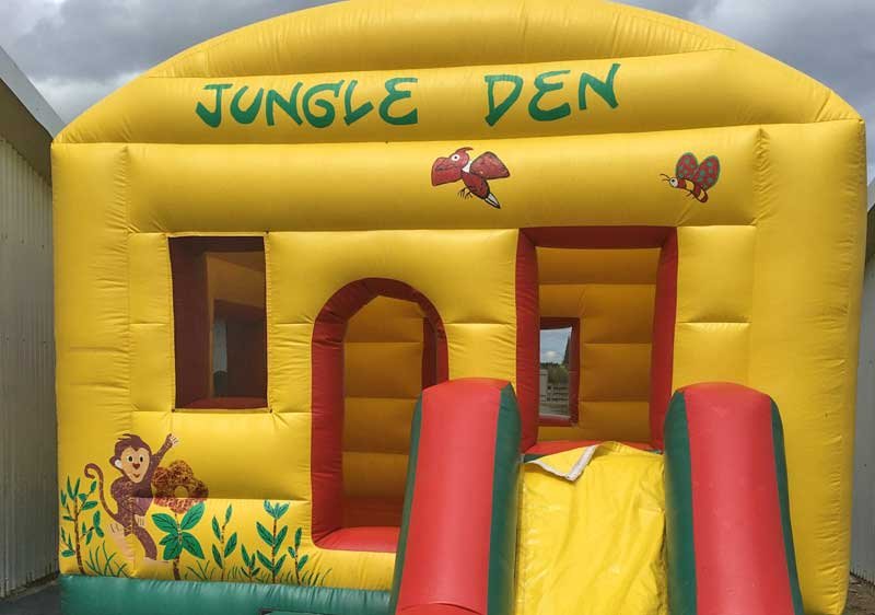 Inflatable playhouse with slide for children's entertainment.